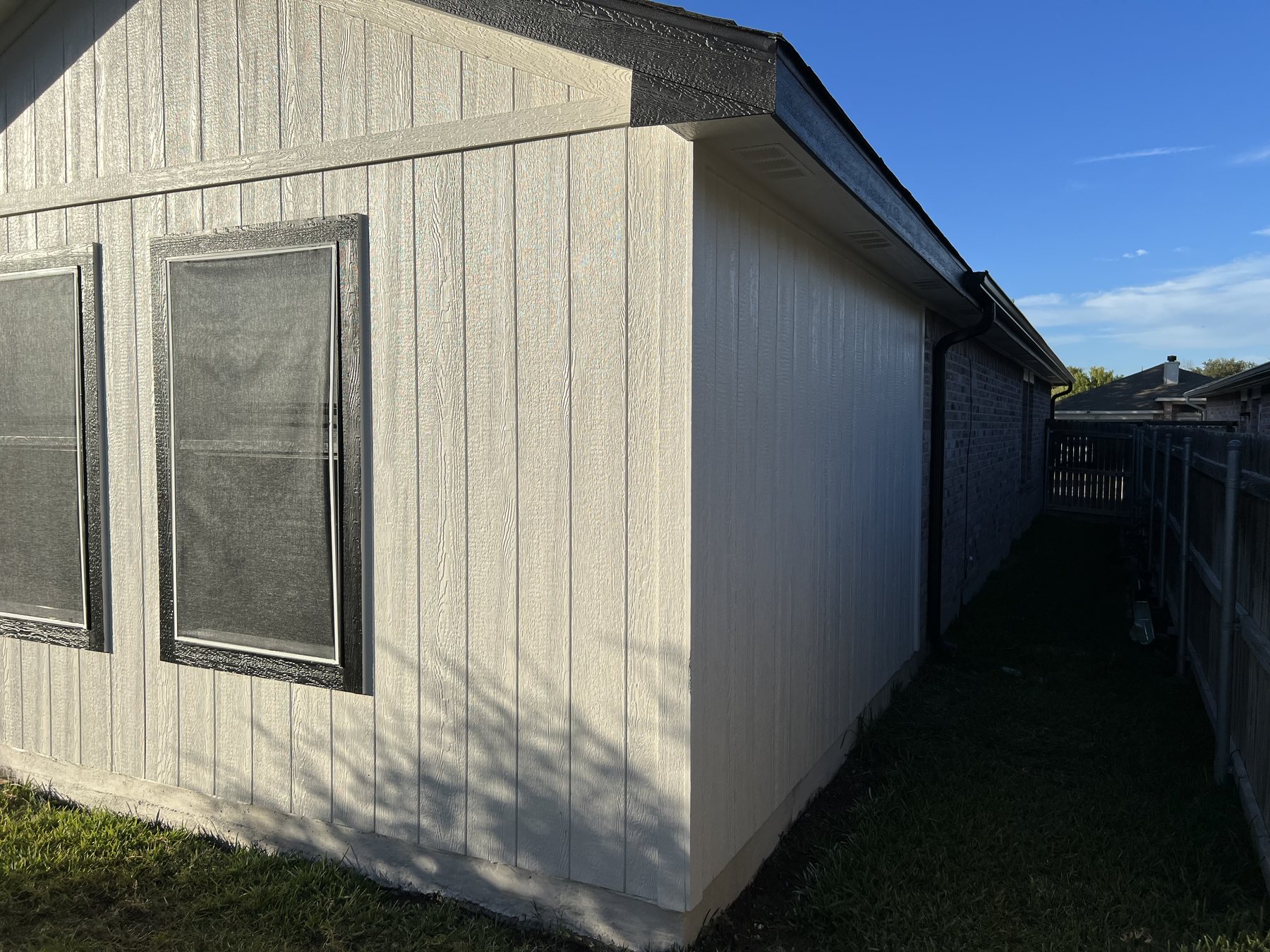 Side elevation of the completed patio addition with matching siding and windows