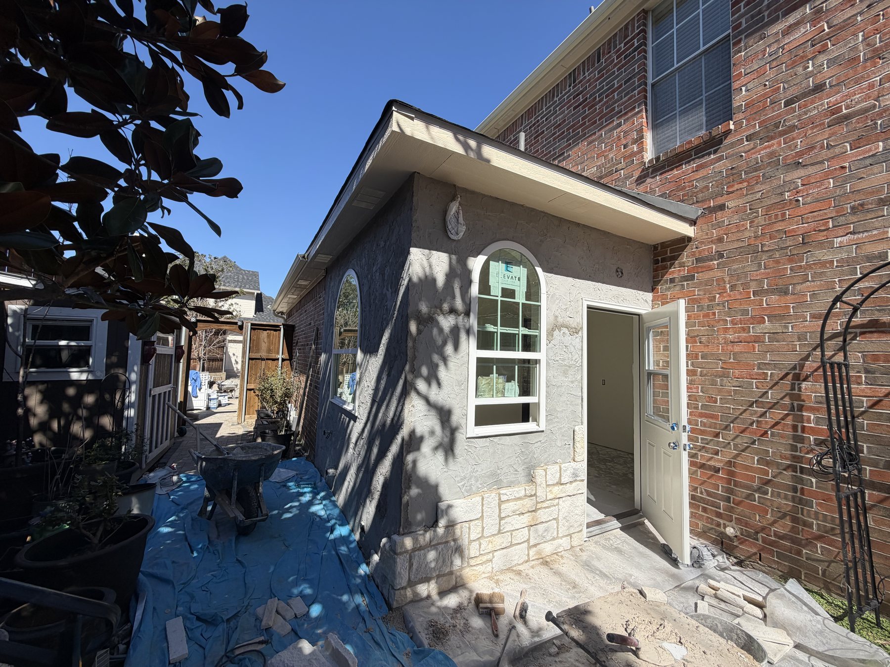 Finished stone entry bumpout with new door and arched window