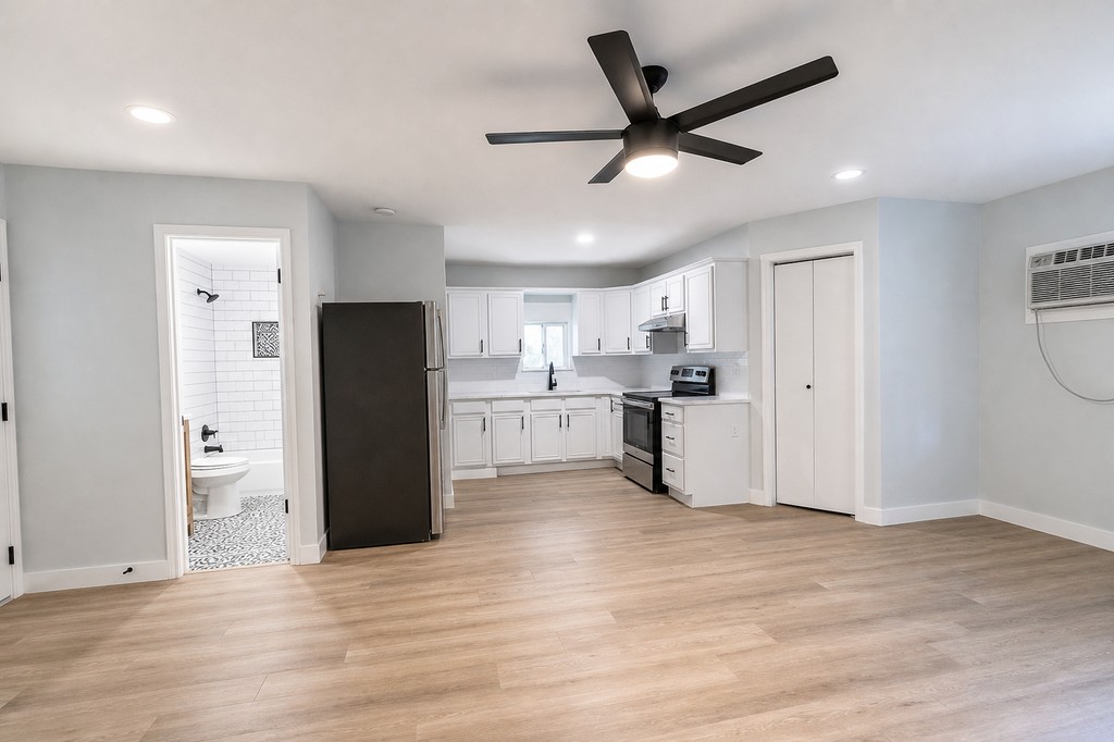 Finished open living and kitchen area with new flooring and paint