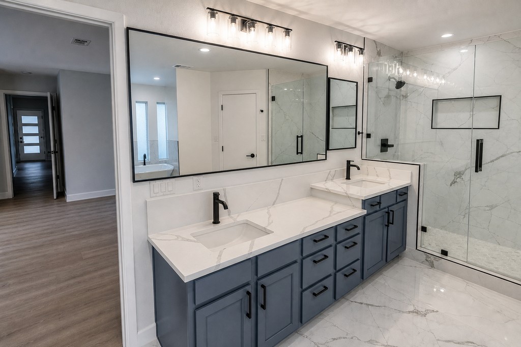 Master bath double vanity with glass shower and marble-look wall tile