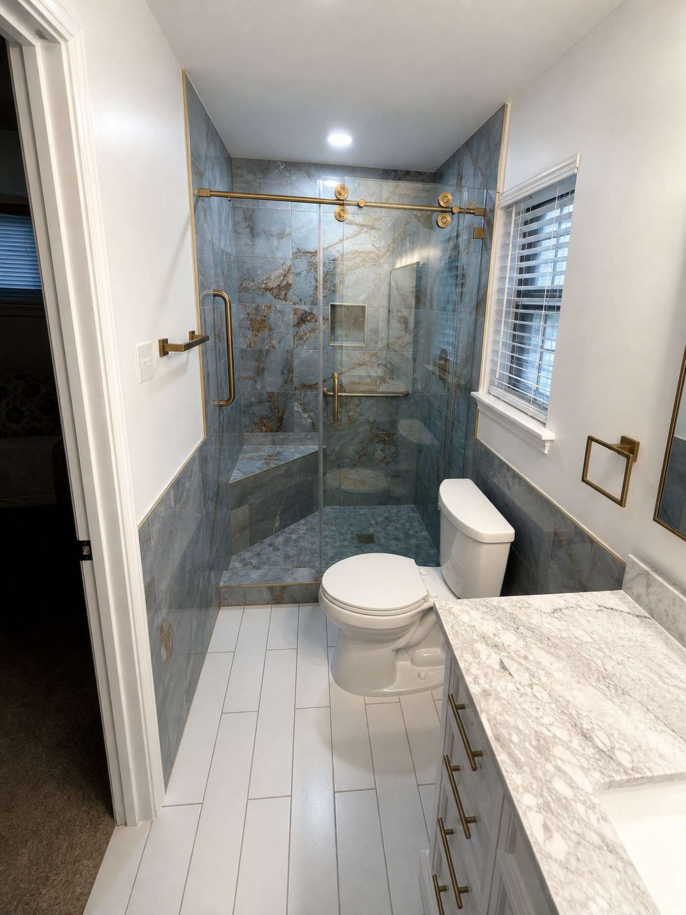 Luxury bathroom shower with dramatic marble-look tile and glass enclosure