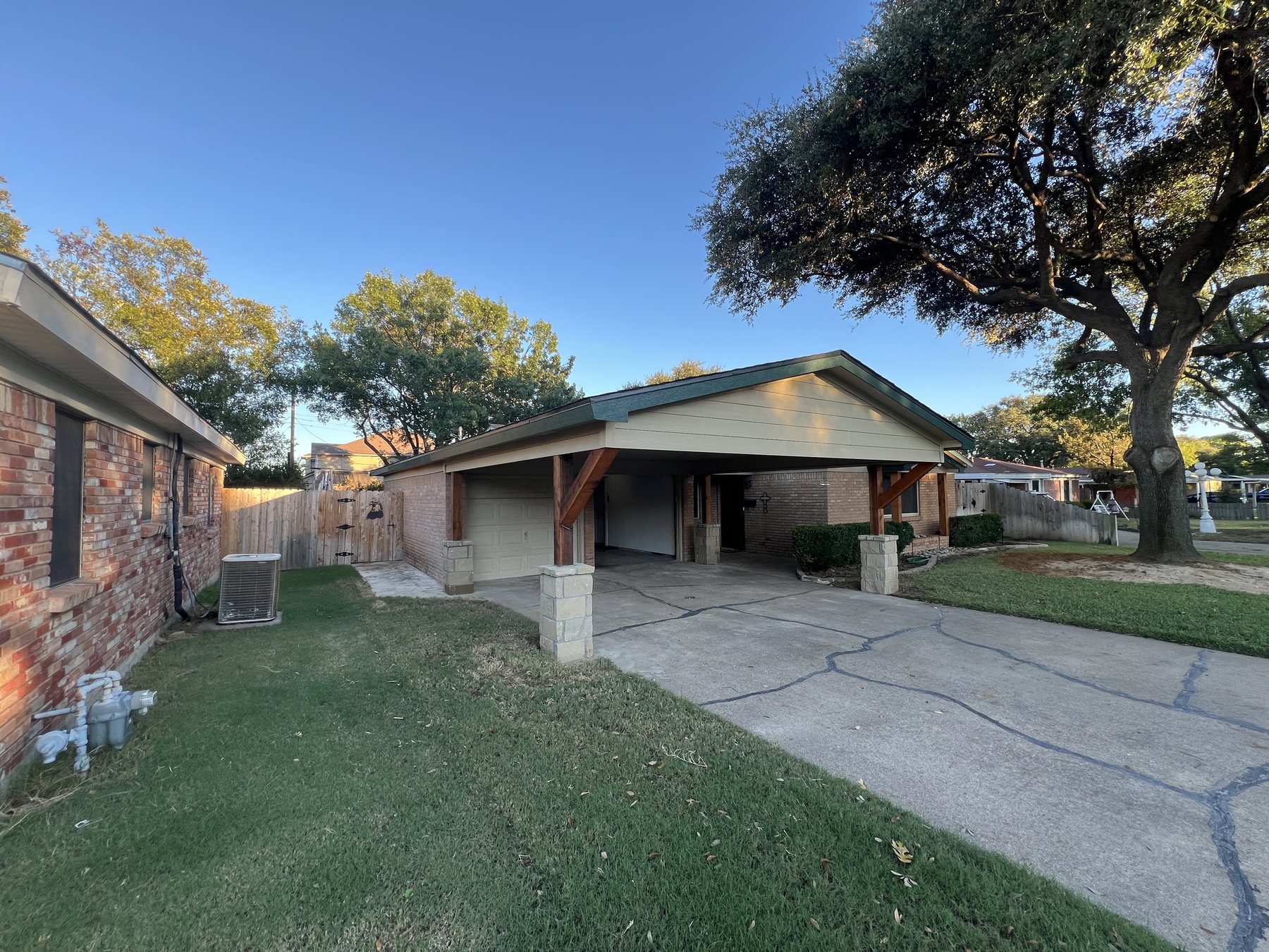 Finished carport structure with roof extension and support columns