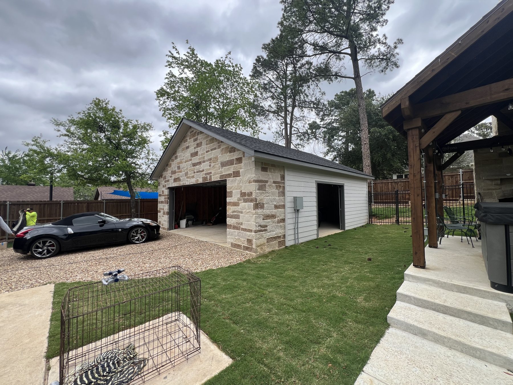 Wide view of the finished garage exterior and side yard improvements
