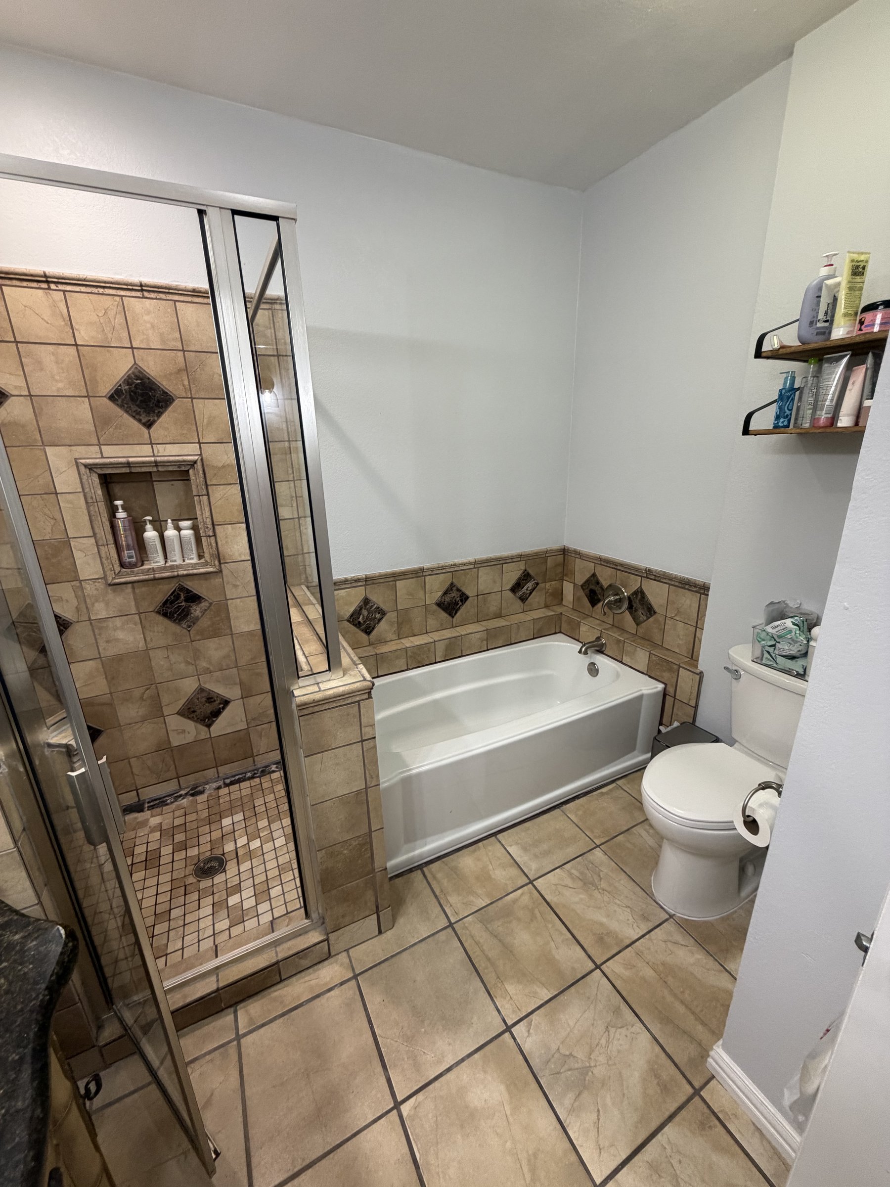 Old tub and dated mosaic tile accent strip — before renovation