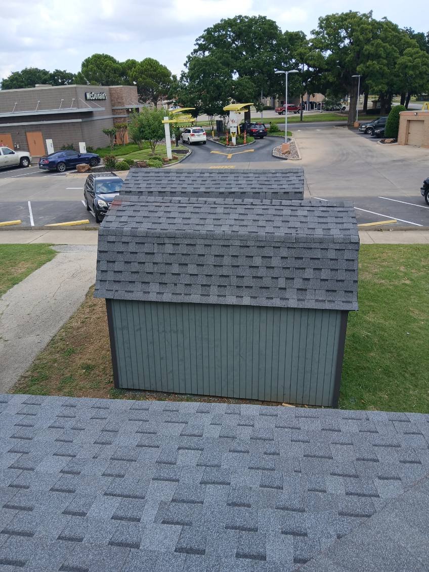 Finished new roof on a residential outbuilding alongside the main building roof