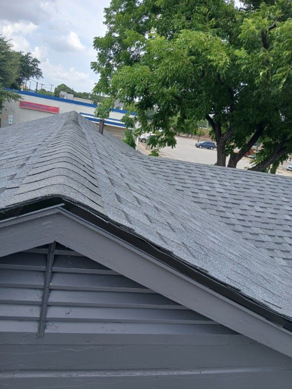Finished roof ridge and peak detail showing valley and ridge cap work